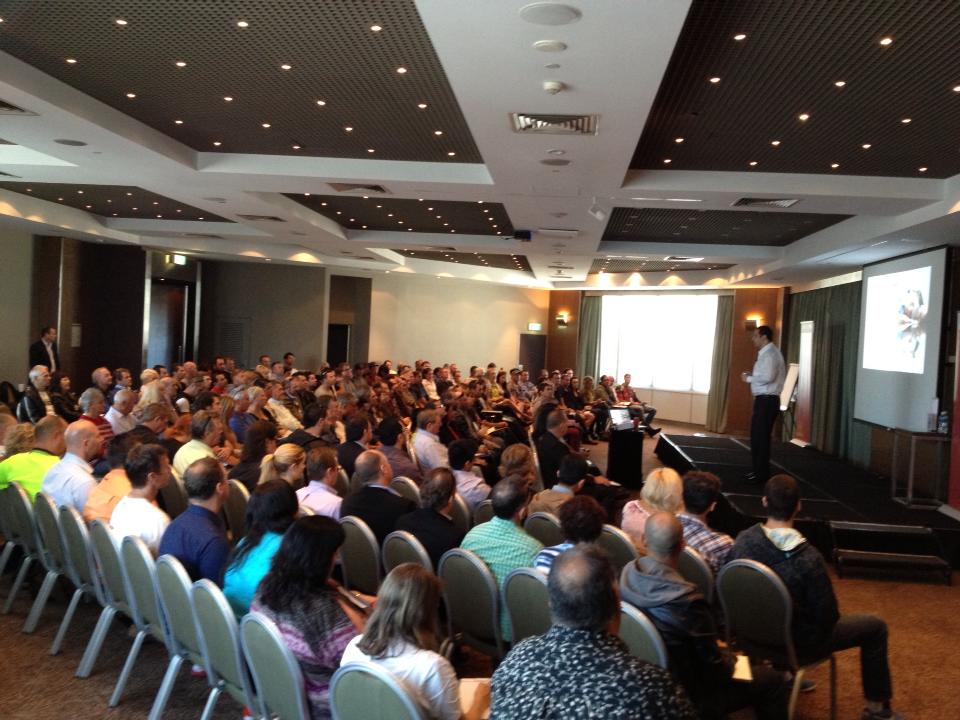 Brendan presenting to packed conference room